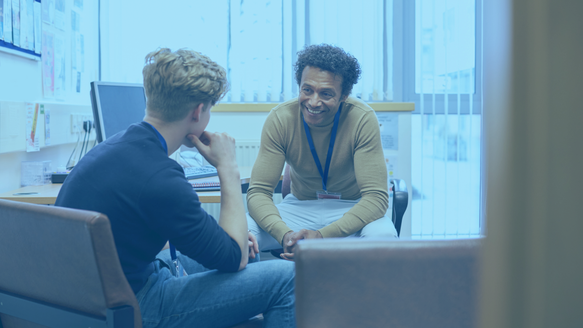 teacher smiling and talking to student individually