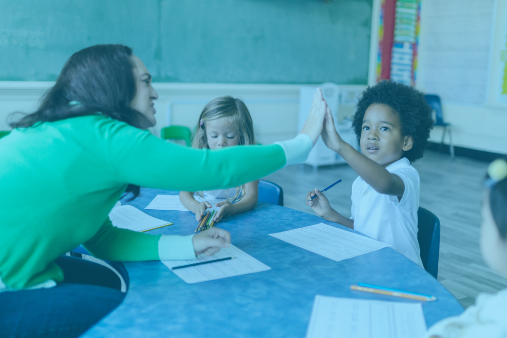 teacher high-fives child